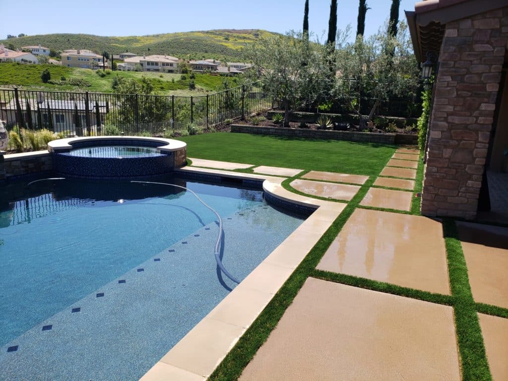 Pala CA Artificial Grass around pool with paver stones